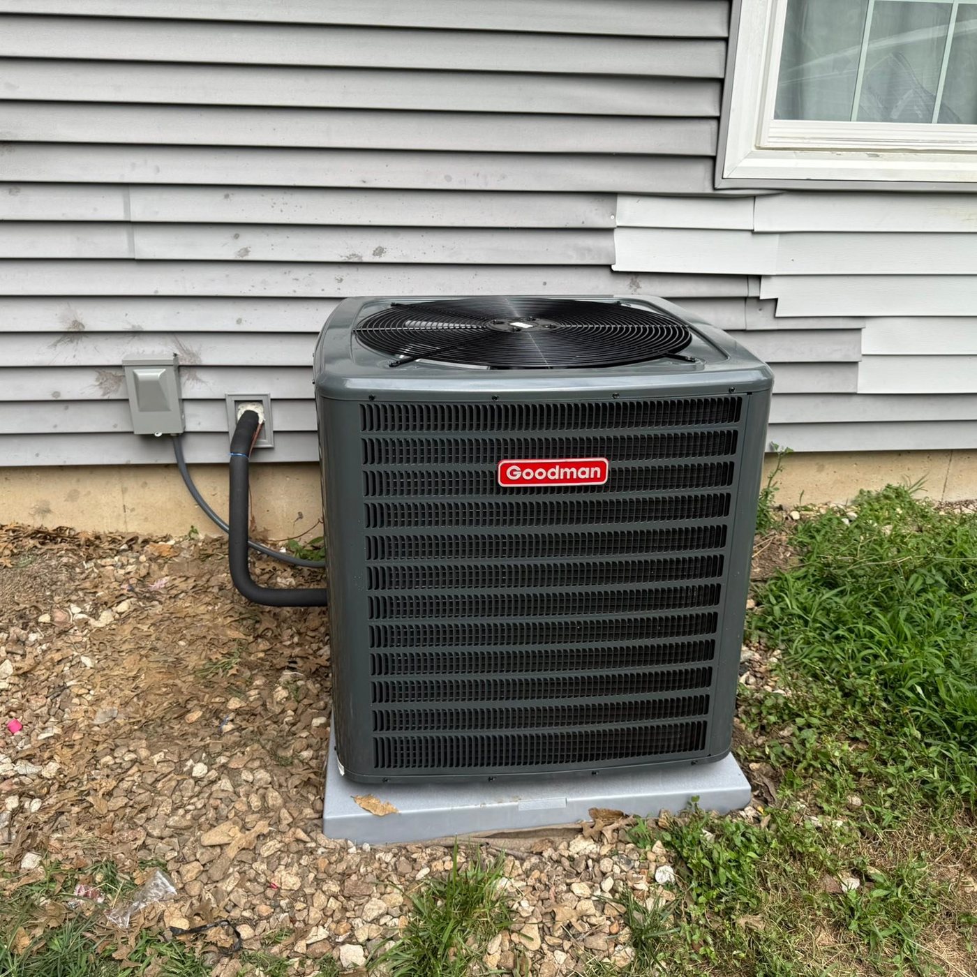 Goodman AC condenser installed on a new outdoor pad