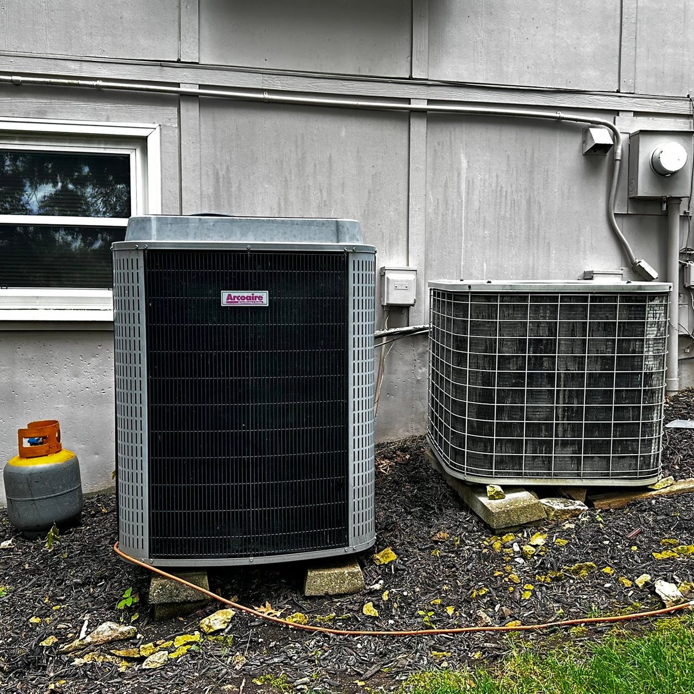 Two outdoor Goodman condenser units installed by TK Heating & Cooling